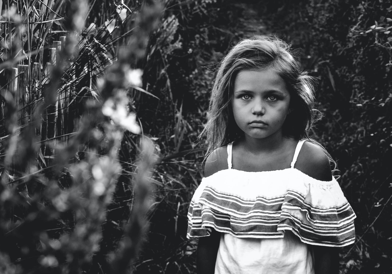 grayscale photo of a girl in garden